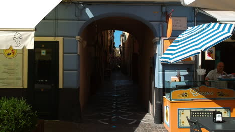 Aerial-view-flying-inside-a-narrow-alley-in-Pietra-Ligure,-in-sunny-Italy