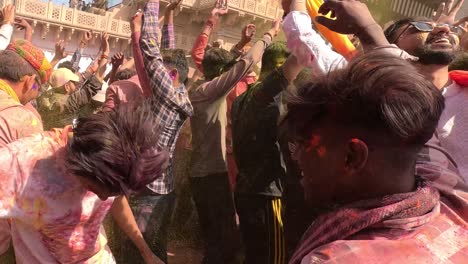 pov-shot-Many-people-are-dancing-outside-the-temple-and-flying-colours