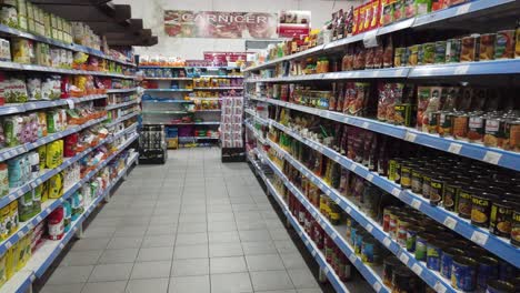 inside-Chinese-store-supermarket-shelves-groceries-of-argentina,-china-people-business-in-south-america,-shop-display-with-products-colorful-stands-of-goods