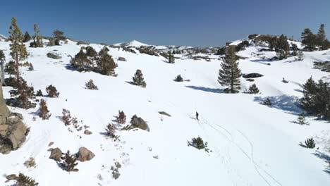 Vista-Aérea-Del-Excursionista-Subiendo-Un-Sendero-Montañoso-Nevado,-Carson-Pass,-California