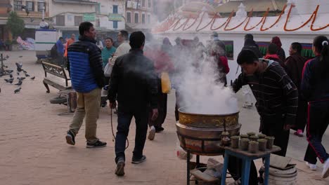 View-amongst-people-walking-around-the-outer-section-of-Boudhanath-Temple,-Kathmandu,-Nepal