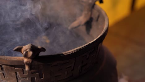 Close-shot-of-incense-burning-in-the-Boudhanath-Temple,-Kathmandu,-Nepal