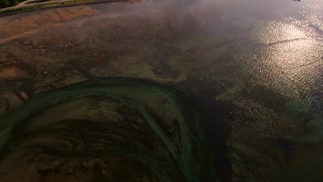 Aerial-of-a-river-delta-surrounded-by-mountains