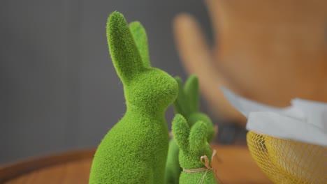 Indoor-green-Easter-bunny-family-decoration-on-wooden-table,-holiday-concept