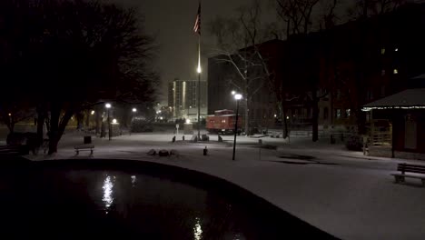 Aerial-night-shot-of-downtown-Lititz-Springs-Park-while-snowing