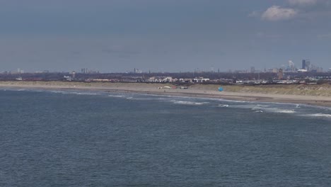 White-Waves-Break-Onto-the-Pristine-Shoreline-of-Hoek-van-Holland-in-the-Netherlands---Aerial-Drone-Shot