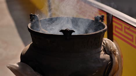 Close-shot-of-incense-burning-near-the-Boudhanath-Temple,-Kathmandu,-Nepal