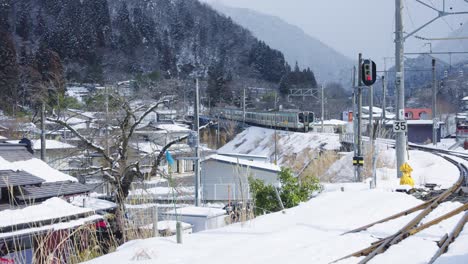 Train-departing-Yamadera-Station-in-Yamagata-Japan,-Snowy-Winter-Landscape-4k