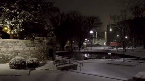 Aerial-nighttime-snowy-shot-of-Lititz-Springs-Park,-going-from-left-to-right