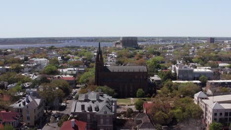 Low-push-in-aerial-shot-of-the-Cathedral-of-Saint-John-the-Baptist-in-Charleston,-South-Carolina
