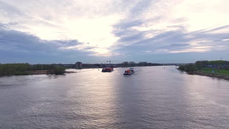 The-Veja-Container-Ship-Navigating-Through-the-Oude-Maas-River-in-Zwijndrecht,-Netherlands---Drone-Flying-Forward