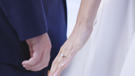 Bride-and-groom-intertwine-hands