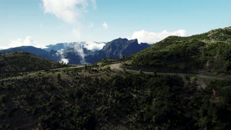 Drone-of-White-Clouds-Moving-Over-Picturesque-Mountain-Road,-4k-Madeira