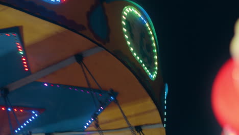 Detailed-closeup-of-sparkling-carnival-lights-on-spinning-ride-at-night