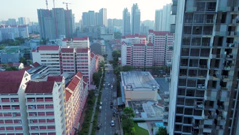 Aerial-drone-landscape-of-main-town-centre-CBD-with-cars-driving-down-street-buildings-towers-urban-area-Farrer-Park-Singapore-Asia-travel-tourism