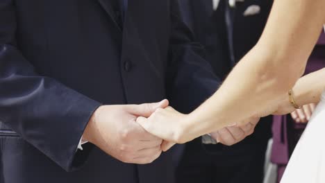 Bride-and-groom-hold-hands-during-ceremony