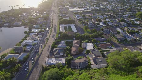 drone-footage-of-cars-and-trucks-driving-down-highway-H1-in-Honolulu-Hawaii-on-the-island-of-Oahu-the-footage-rotates-to-follow-the-traffic-on-a-sunny-day