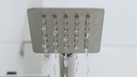 Water-Flowing-Dropping-From-Shower-Head-Then-Shut-Off,-Close-Up