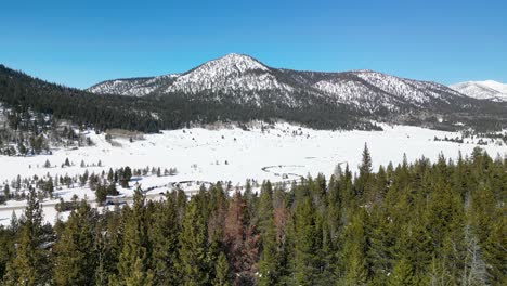 Aerial-view-of-forest-and-mountains-in-Lake-Tahoe,-California-winter