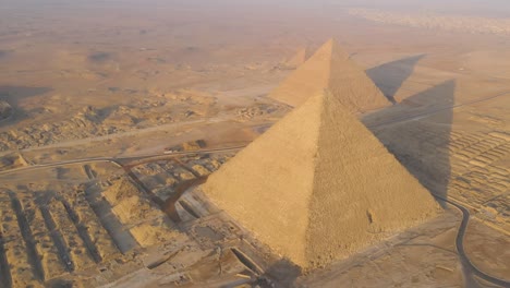 An-aerial-perspective-reveals-the-grandeur-of-the-Great-Pyramids-of-Giza,-the-Pyramids-Plateau,-and-the-iconic-Sphinx-in-Egypt,-capturing-the-essence-of-ancient-marvels-and-enduring-magnificence