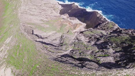 drone-footage-beginning-in-a-large-crater-on-a-volcanic-formation-off-the-coast-of-Oahu-in-the-Hawaiian-islands-and-backing-to-reveal-the-island-surrounded-by-blue-ocean-water-of-the-Pacific