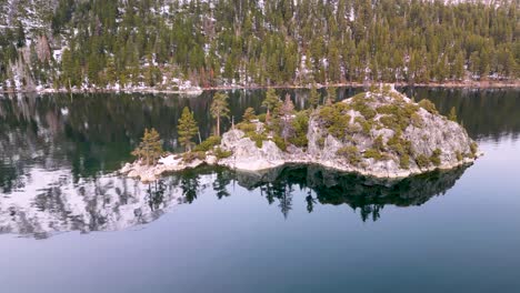 Aerial-view-of-Emerald-Bay-island-with-mountains-in-water-reflection,-Lake-Tahoe,-California