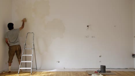 Scene-Of-A-Man-Limewash-Painting-A-Wall-Of-A-Renovated-Room