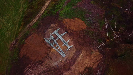 Parts-of-a-high-voltage-pylon-to-be-installed-lie-on-the-ground