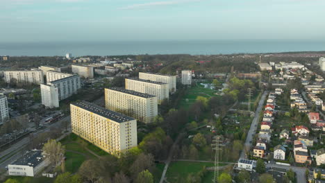 Drone-view-of-modern-apartments-of-Gdansk,-Zabianka-with-cityscape-at-background