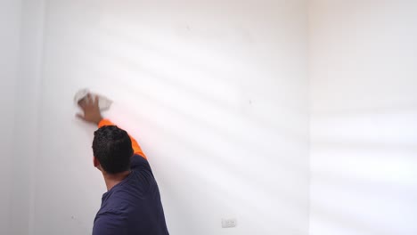 Man-With-Rag-Cleaning-Wall-At-Home,-Preparation-For-Room-Painting---Close-Up