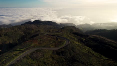 Aerial-of-Scenic-Curvy-Road-Above-the-Clouds-in-the-Mountains