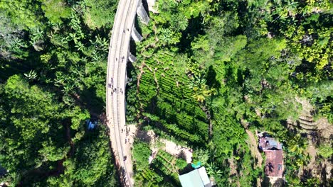 Aerial-drone-landscape-view-of-Ella-Nine-Arch-Bridge-railway-tourism-landmark-architecture-in-farming-forest-Sri-Lanka-Asia-travel-tourism-transport