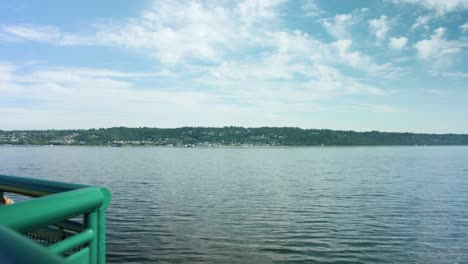 Shot-looking-out-over-a-boat's-handrail-at-Washington's-shoreline