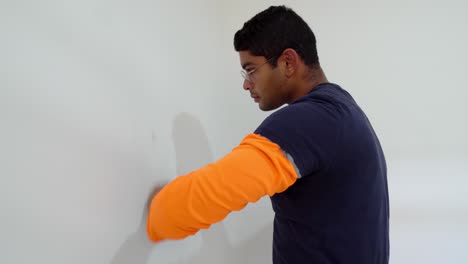 Man-Using-a-Rag-to-Clean-Walls-in-Preparation-for-Painting-a-Room-at-Home---Static-Shot