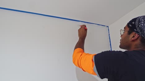 Man-Painting-Wall-With-White-Paint-Using-Brush---Close-Up