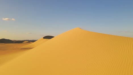 Aerial-perspective-reveals-the-dunes-in-the-Western-Desert-of-Egypt,-the-concept-of-sandy-landscape,-the-allure-of-nature-under-the-sun,-and-the-vast-expanse-of-a-dry-and-desolate-terrain