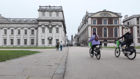 The-timeless-charm-of-the-Old-Royal-Naval-College-in-Greenwich,-London,-as-visitors-leisurely-stroll-along-College-Way-Road,-embodying-the-concept-of-historical-heritage-and-cultural-exploration