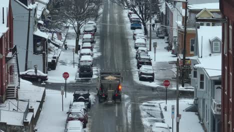 Aerial-view-of-Snow-plowing-service-gritting-and-salting-streets-during-snowy-winter-in-USA