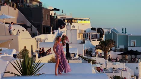 Woman-with-long-hair-blowing-in-the-wind-and-a-loose-dress-is-looking-at-the-sunset