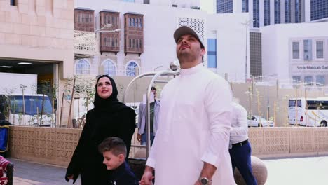 Muslim-family-acknowledging-and-admiring-the-city-of-Mecca,-Saudi-Arabia