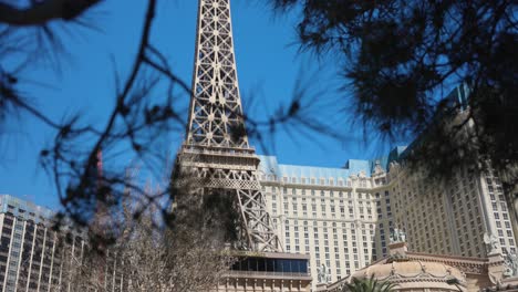 Eiffel-tower-at-Paris-Las-Vegas-resort-viewed-through-tree-branches-on-sunny-day