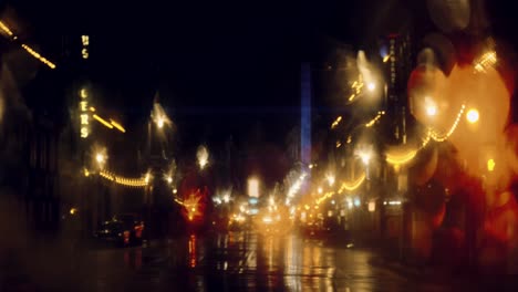 Rainy-Night-in-an-urban-city-environment,-Bright-Lights-Shining-in-Anamorphic-Shot,-Milwaukee,-Wisconsin