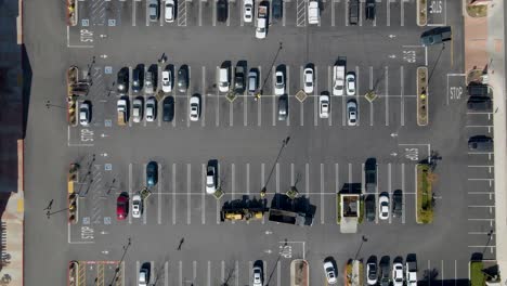 High-top-down-drone-shot-captures-static-view-of-grocery-store-parking-lot