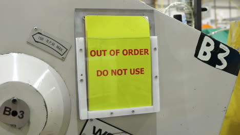 Out-of-order-do-not-use-sign-in-clear-plastic-display-on-side-of-industrial-machine