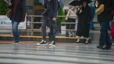 Legs-Of-Pedestrians-Walking-At-Zebra-Crossing-In-Shibuya,-Tokyo,-Japan