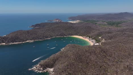 4K-video-clip,-drones-in-Huatulco,-Mexico,-Oaxaca,-summer-destination,-sunny-beaches-and-mountains-in-background