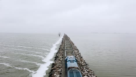 Drone-meets-freight-train-transporting-stone-on-seaside-railroad-in-Argentina