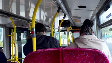 Passengers-travel-aboard-a-local-bus-in-central-London,-illustrating-the-concept-of-urban-mobility-and-public-transportation-efficiency