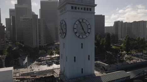 Drone-circles-and-ascends-very-closely-to-the-San-Francisco-Ferry-Building-clock-tower-on-clear-day,-offering-360-degree-city-view-from-Embarcadero