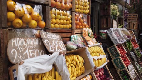 Closeup-shot-Fruit-store-market-Argentina-Prices-fresh-products-bananas-oranges-tomatoes-in-city-streets